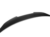 Curved, black carbon fiber spoiler angled diagonally, isolated against a plain white background, emphasizing its streamlined design and aerodynamic function.