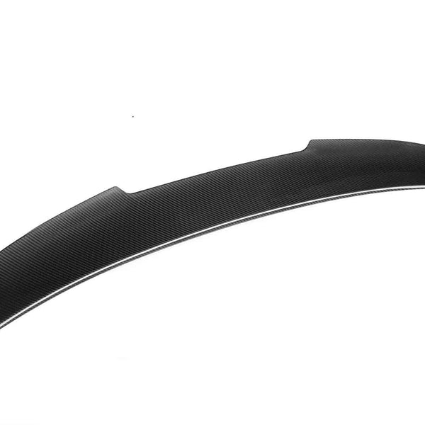 Curved, black carbon fiber spoiler angled diagonally, isolated against a plain white background, emphasizing its streamlined design and aerodynamic function.