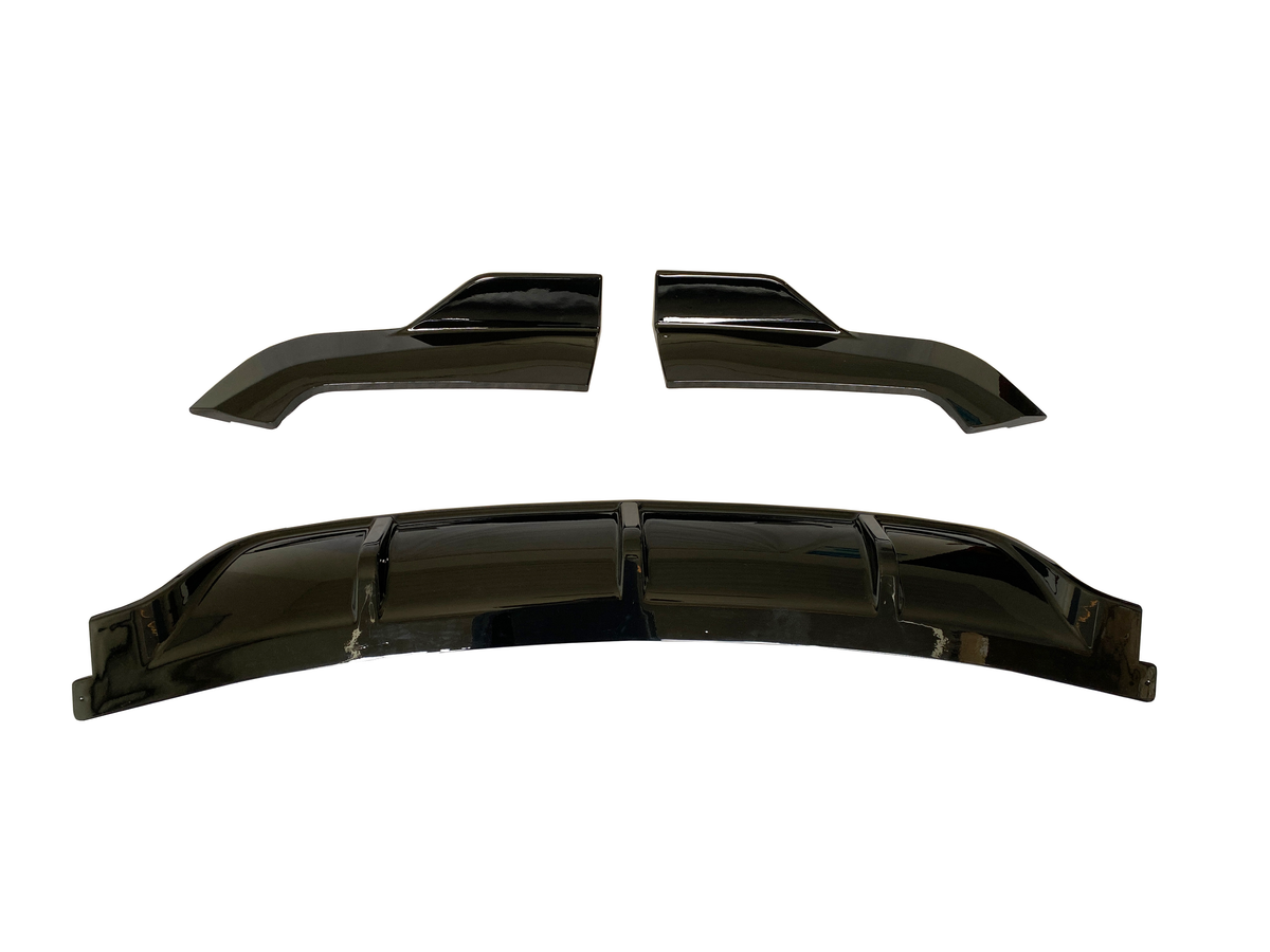 Two glossy black automotive parts rest on a white background. The top piece consists of two angled sections, while the bottom is a slightly curved, segmented cover.