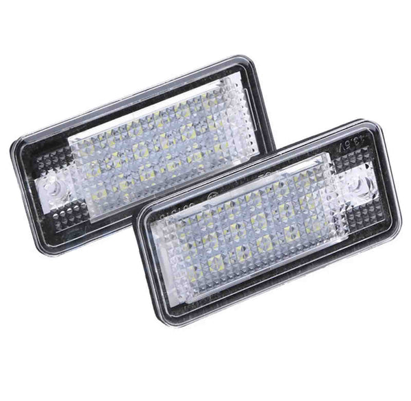 Rectangular LED lights are positioned diagonally, displaying a grid of small lights within clear, textured covers, set against a plain white background.