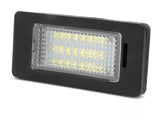 A rectangular black LED light exhibits a grid of illuminated yellow diodes beneath a textured clear cover, positioned on a plain white background.