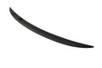 A sleek, black car spoiler lies on a plain white surface, curving slightly upward at the ends.