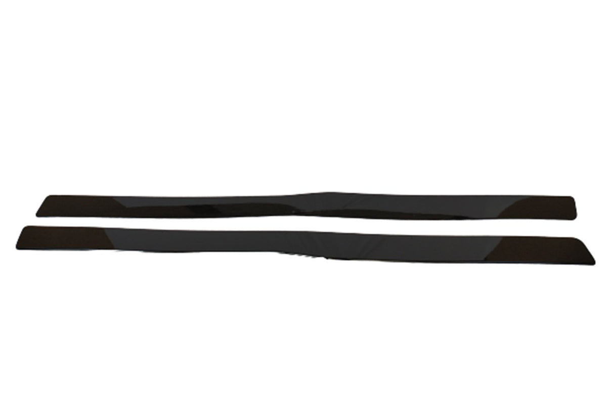 Two sleek, black plastic strips lie parallel on a plain white background, possibly components for a car or device, emphasizing simplicity and modern design.