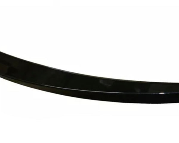 A sleek, black, curved car spoiler rests against a plain white background, showcasing its aerodynamic design and glossy finish.