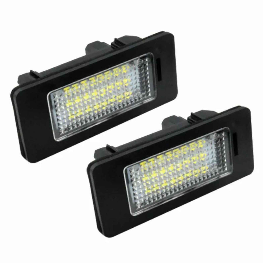 Two rectangular LED lights with black plastic housing and a grid-like lens, positioned diagonally against a plain white background.