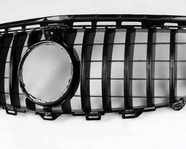A black car grille with vertical slats and a central circular opening lies against a plain white background.