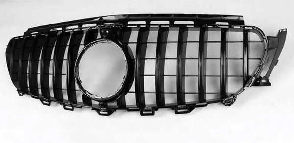 A black car grille with vertical slats and a central circular opening lies against a plain white background.
