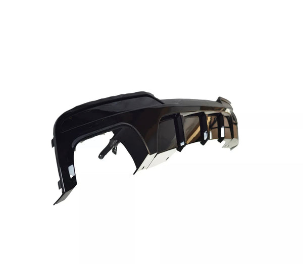 A sleek, black car bumper with aerodynamic features is positioned diagonally. It is suspended against a plain white background, highlighting its glossy surface and intricate design elements.