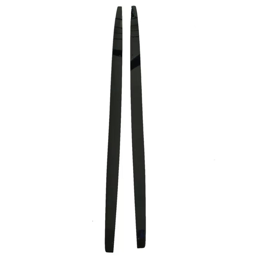 Two black, shiny chopsticks are positioned parallel to each other on a plain white background. The chopsticks are straight, slender, and taper towards one end.