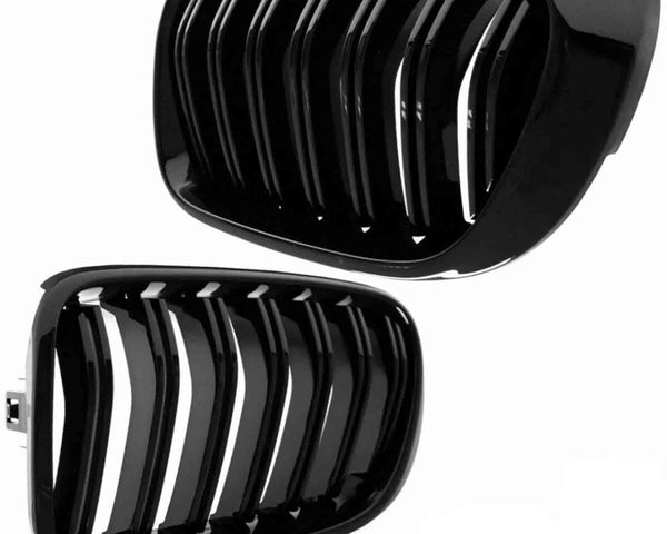 Two glossy black car grilles with vertical slats are displayed against a plain white background, showing different angles of each grille.