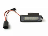 A rectangular LED light with attached red and black wires is placed against a white background, highlighting its connectivity aspect.