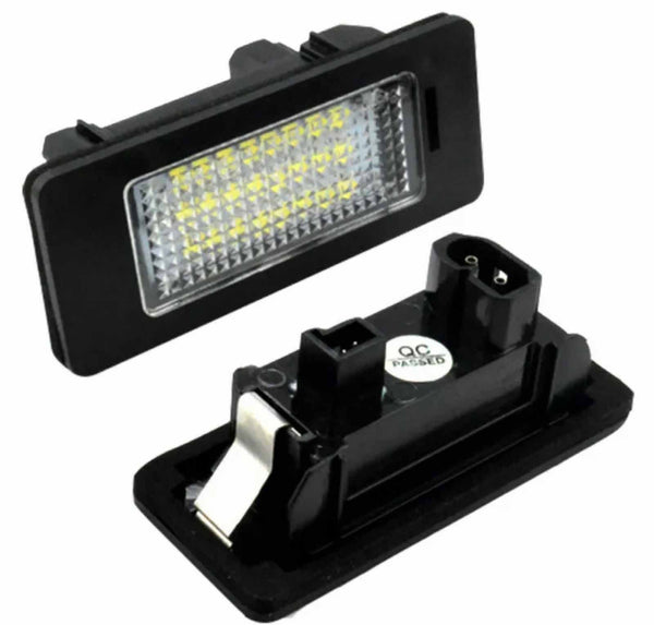 An LED car license plate light, featuring a rectangular black frame and numerous small yellow bulbs, is shown separately alongside its rear side marked with “QC PASSED.”