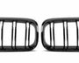 A pair of black car grilles with vertical slats, positioned side by side on a plain white background, designed for air intake on a vehicle's front end.