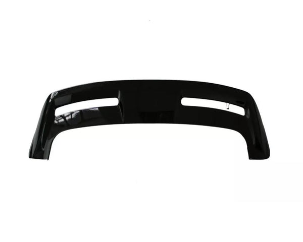 Curved black vehicle bumper with two elongated openings, shown against a plain white background.
