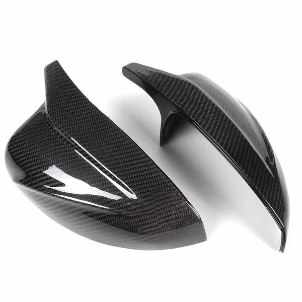 Two glossy carbon fiber mirror covers are displayed on a white background, highlighting their sleek, aerodynamic design and texture.