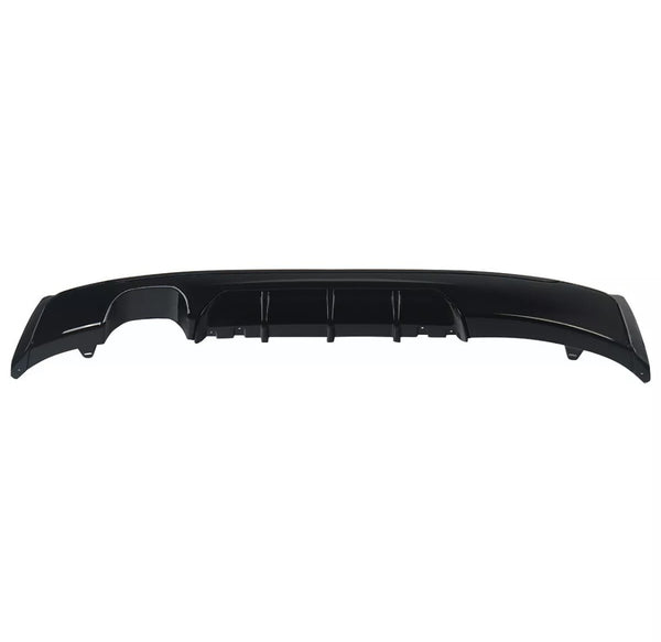 A glossy black car bumper diffuser features several vertical fins, positioned horizontally. It is shown against a plain white background, highlighting its streamlined design and contours.
