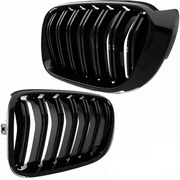 Two glossy black car grilles with vertical slats are positioned diagonally, contrasting against a plain white background. The grilles have a sleek, modern design with shiny reflections.