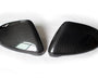 Two carbon fiber car side mirror covers lying on a white surface, displaying a sleek, glossy pattern with no visible text.