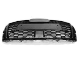 A black car grille features a honeycomb pattern and a rectangular central section, positioned against a plain white background.