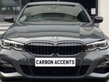 A gray BMW car is parked, facing forward with sleek design elements. Text on the front reads 