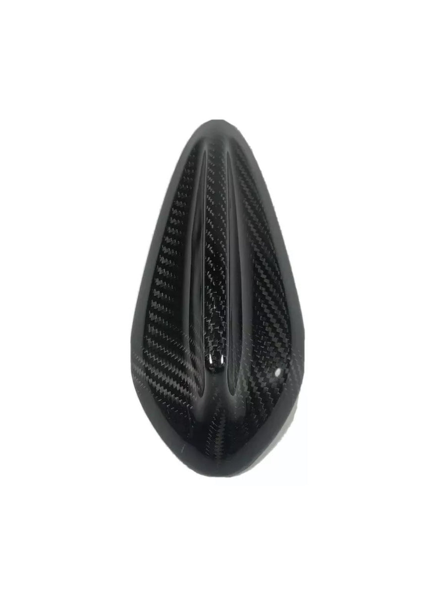 A black, teardrop-shaped carbon fiber object, featuring three central ridges. It is positioned against a plain white background.