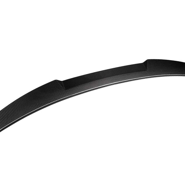 A curved carbon fiber car spoiler is shown on a white background, emphasizing its aerodynamic design and smooth texture.