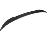 A black, curved carbon fiber spoiler with a textured surface is displayed against a plain white background, highlighting its sleek aerodynamic design.