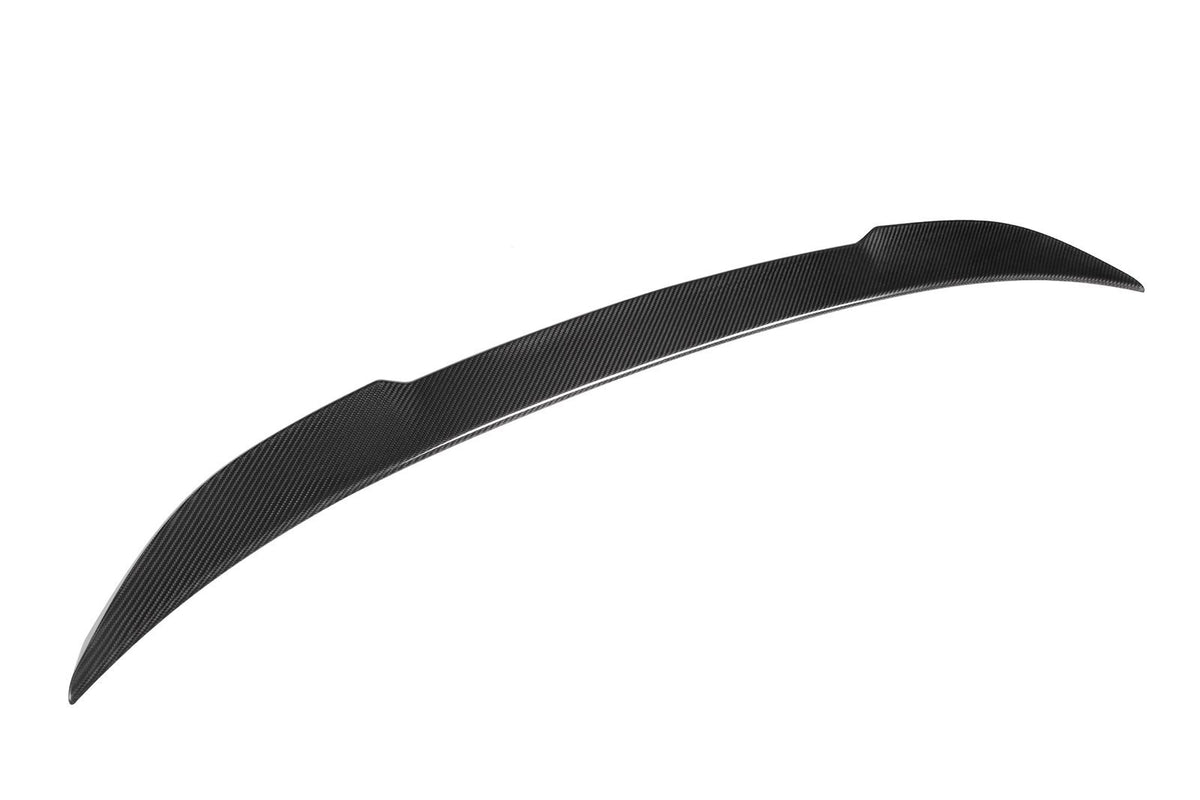 A black, curved carbon fiber spoiler with a textured surface is displayed against a plain white background, highlighting its sleek aerodynamic design.