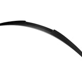 A curved, sleek black spoiler made of carbon fiber is presented against a plain white background, highlighting its aerodynamic design and glossy texture.