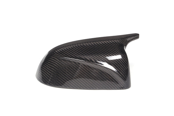 Carbon fiber side mirror cover, glossy and textured, positioned on a plain white background.