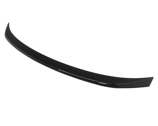 A black car spoiler curves gracefully, designed for aerodynamic effect, isolated against a plain white background.