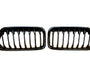 Two black car grilles with vertical slats are displayed side by side against a plain white background.