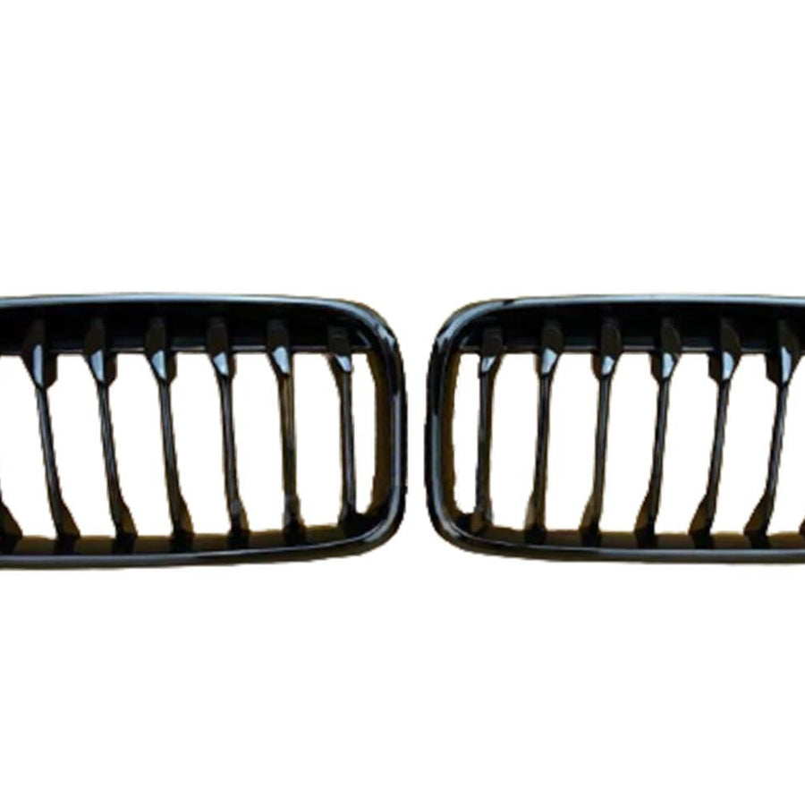 Two black car grilles with vertical slats are displayed side by side against a plain white background.