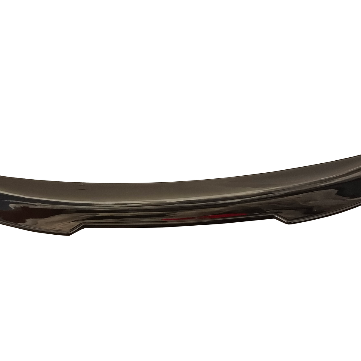 A curved, glossy black car spoiler rests against a plain white background, reflecting light on its smooth, aerodynamic surface.