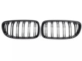 Two black, oval grilles with vertical slats are positioned side by side on a plain white background.
