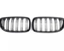 Two black, oval grilles with vertical slats are positioned side by side on a plain white background.