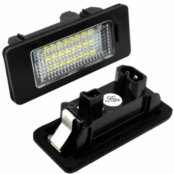 A rectangular LED car light illuminates with a grid of bright yellow LEDs. The black casing shows two connector points. A sticker reads, "QC PASSED."