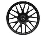 A black, multi-spoke car wheel rim with a central emblem and 
