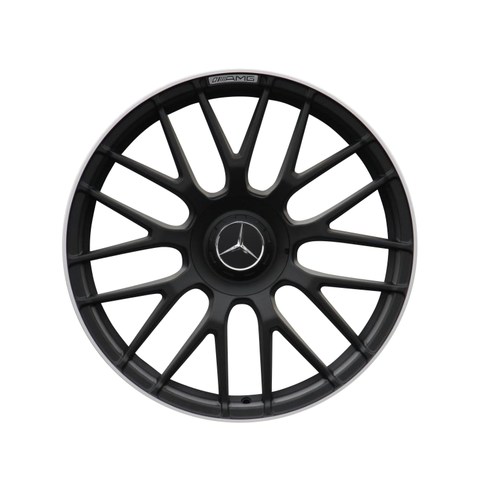 A black multi-spoke car wheel rim features a central Mercedes-Benz logo with the text "AMG" on the edge, set against a plain white background.