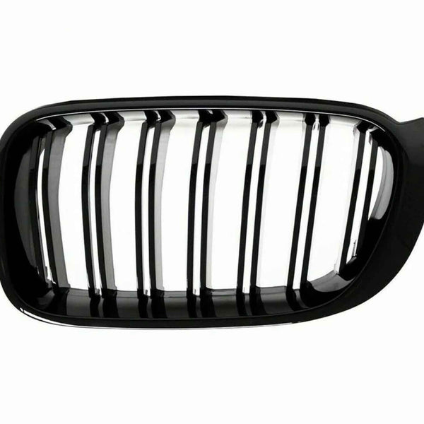 A black car grille with vertical slats, designed for ventilation, is set against a plain white background. The grille has a glossy finish and an oval shape.