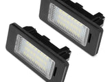 Two rectangular LED license plate lights positioned against a plain white background, featuring black frames and clear lenses revealing multiple small LED bulbs inside.