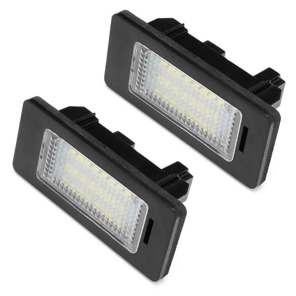 Two rectangular LED license plate lights positioned against a plain white background, featuring black frames and clear lenses revealing multiple small LED bulbs inside.