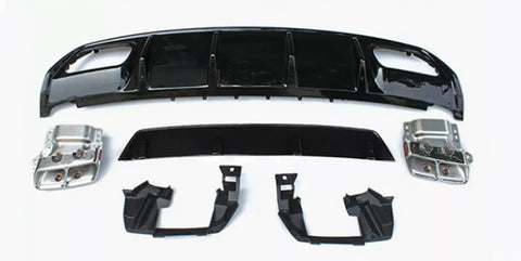 Assorted car parts, including a large black bumper and metallic components, are laid out on a plain white surface, arranged neatly for display or assembly.