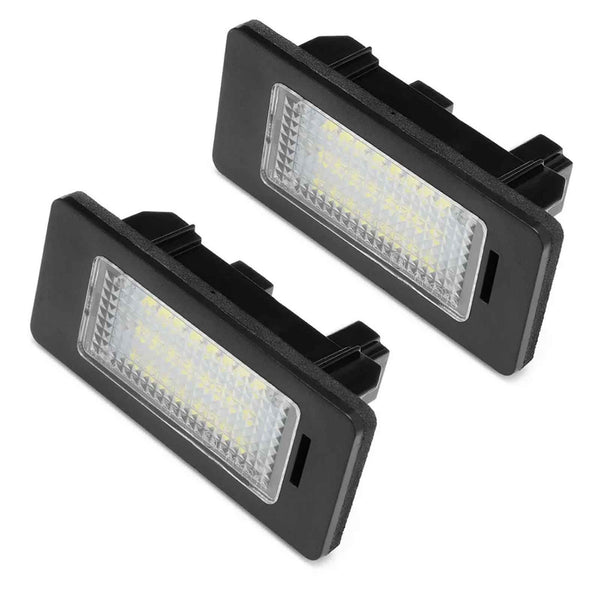 Two rectangular LED car lights, encased in black frames, are positioned at an angle, displaying a grid of yellow diodes. The background is plain white.