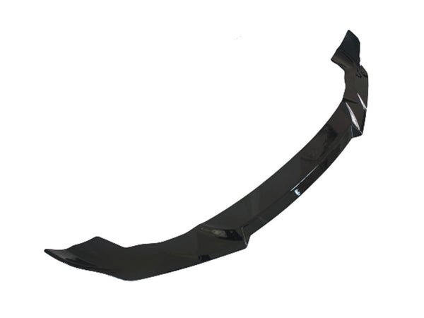 A glossy black car front splitter, designed to enhance aerodynamics, lies against a plain white background.
