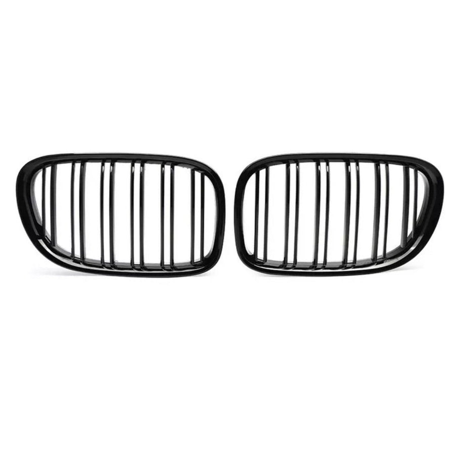 Two black, oval car grilles with vertical slats stand side by side against a white background, highlighting their sleek, symmetrical design.