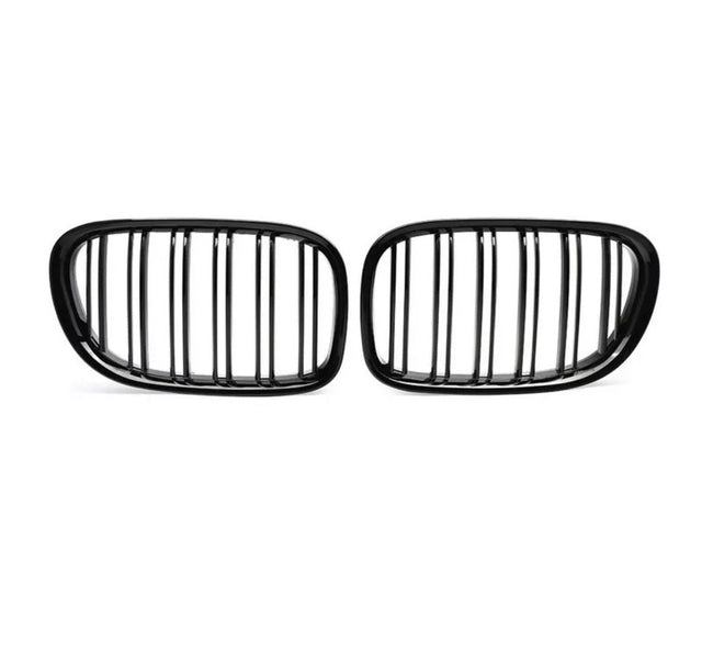 Two black, oval car grilles with vertical slats stand side by side against a white background, highlighting their sleek, symmetrical design.