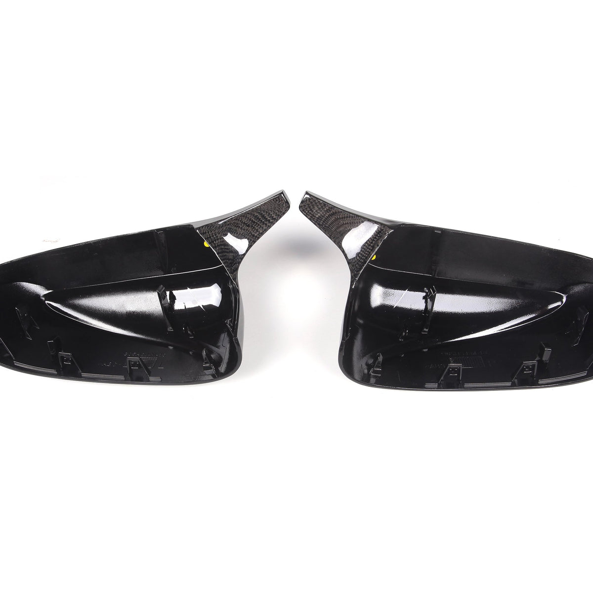 Two glossy black car side mirror covers with a carbon fiber texture are placed side by side on a plain white background.