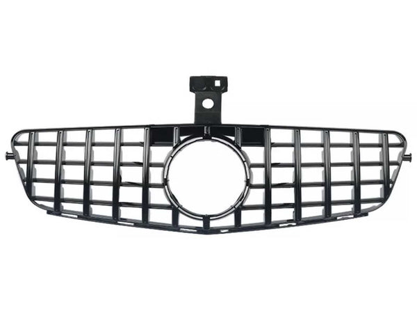 A black car grille with a rectangular grid pattern and central circular opening, positioned horizontally on a white background.