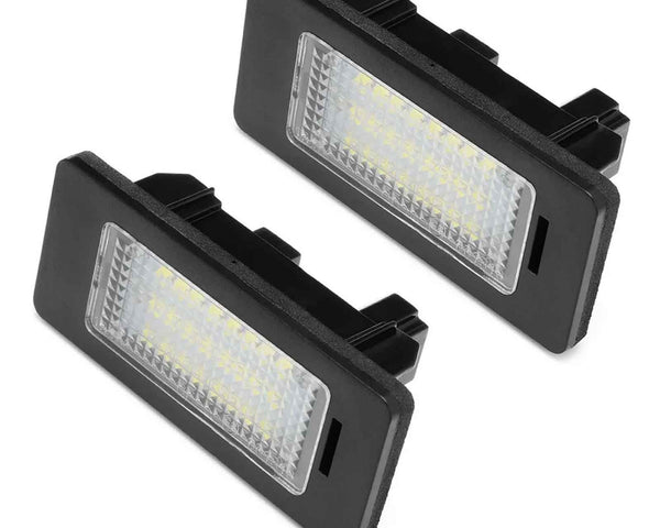 Two rectangular LED lights with black frames are positioned against a white background, showing their textured lens covers and connectors on the back.